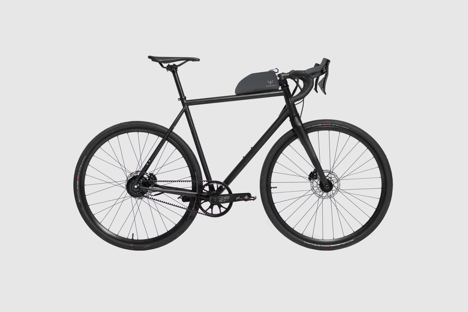 Booda Bike Alpine 3x3 gravel bike in matt black, side view, with belt drive, drop handlebar and an Apidura top tube bag