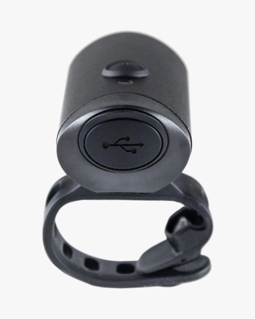 Rear of the Glow front light with a round cap marked with the USB symbol and the silicone strap around the body