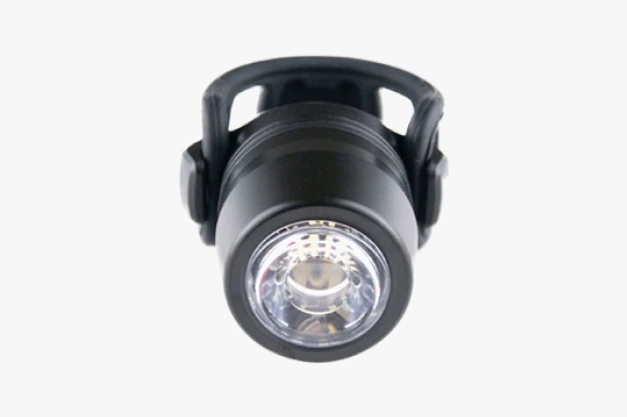 Booda Bike Reflection Mini front light: a short black cylindrical body with a white front lens, held in an open black silicone cage strap