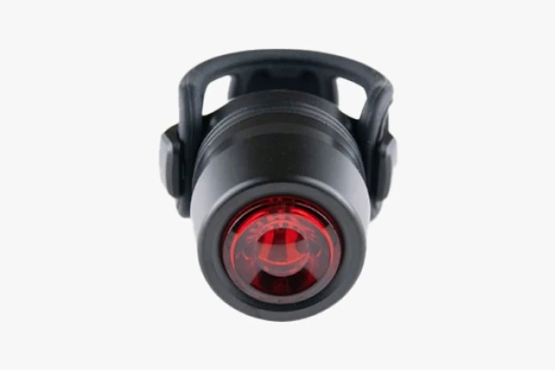 Booda Bike Reflection Mini rear light: a short black cylindrical body with a round red lens, held in an open black silicone cage strap