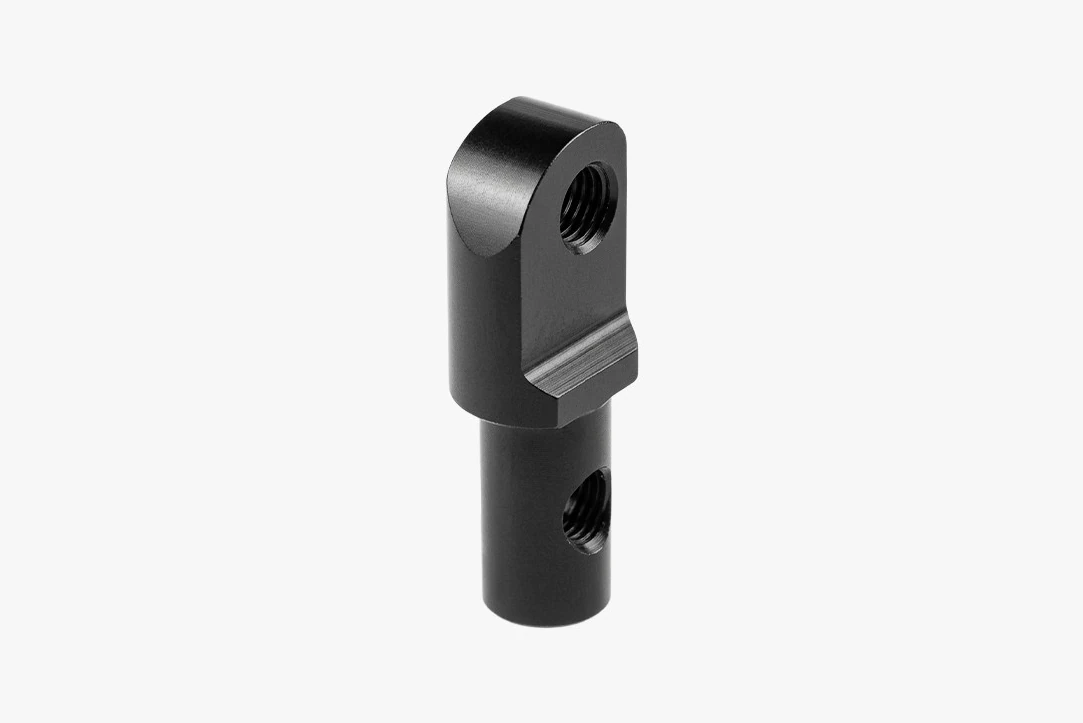 Black rear light mounting adapter with a threaded hole in its angled head and a second threaded hole in the round body below
