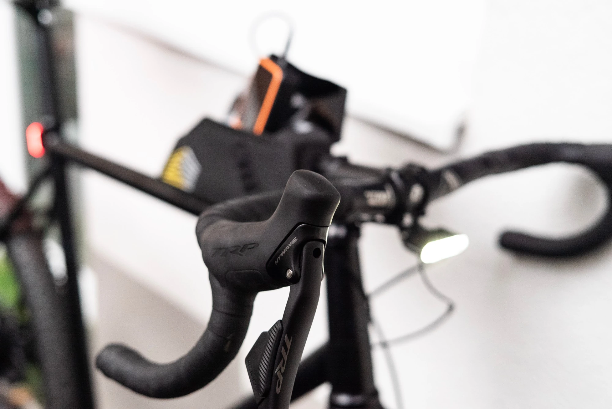 Close-up of the TRP Hywave brake-shift lever on the Booda Bike Alpine 3x3 bent gravel handlebar, with the Apidura top tube bag in the background