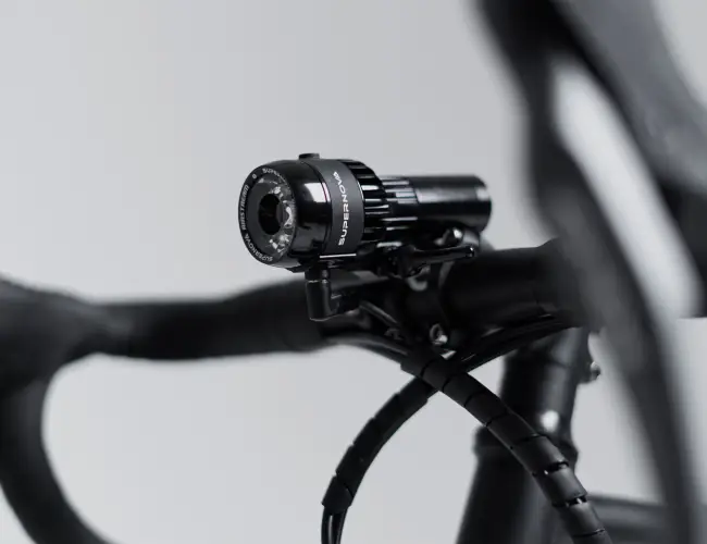 Supernova battery-powered headlight mounted on the handlebar of the Booda Bike Alpine