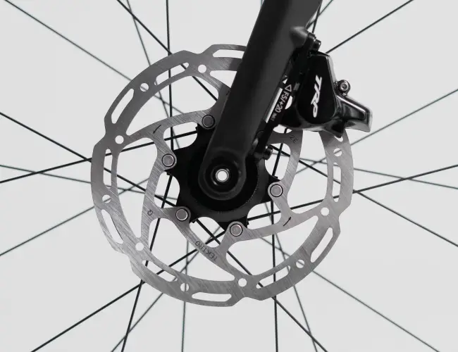 TRP hydraulic disc brake caliper and rotor on the front wheel, close-up
