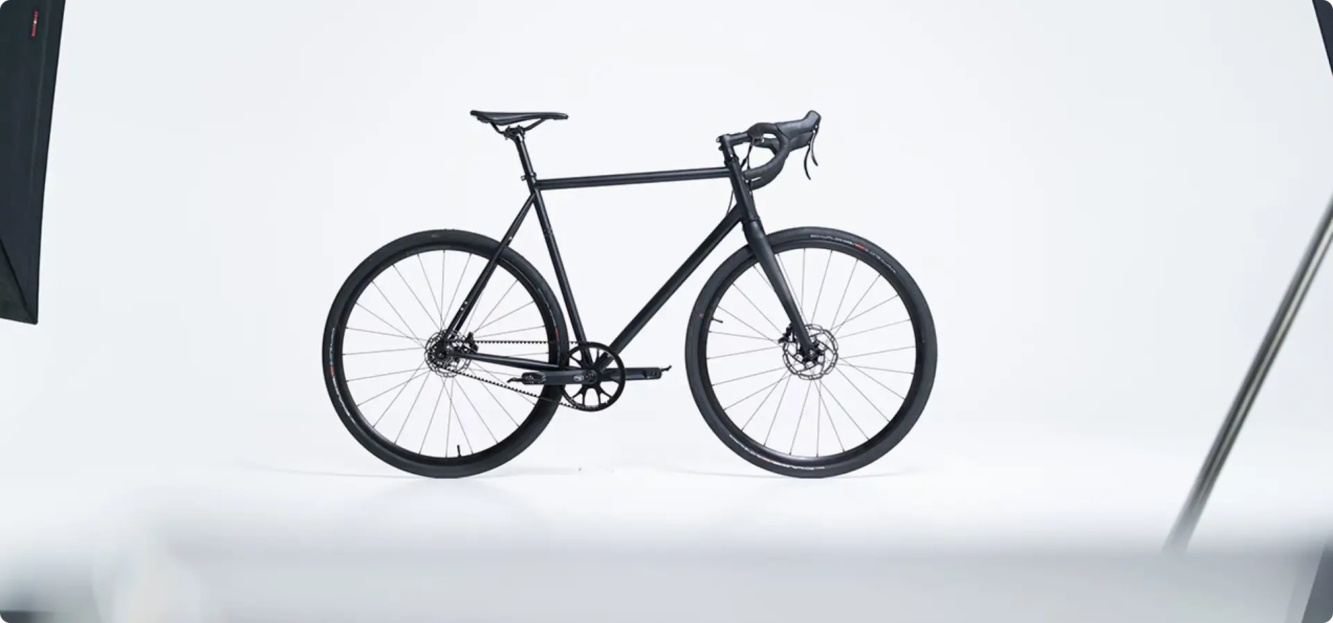 Black Booda Bike Atlas single-speed gravel bike with a drop handlebar, seen from the side