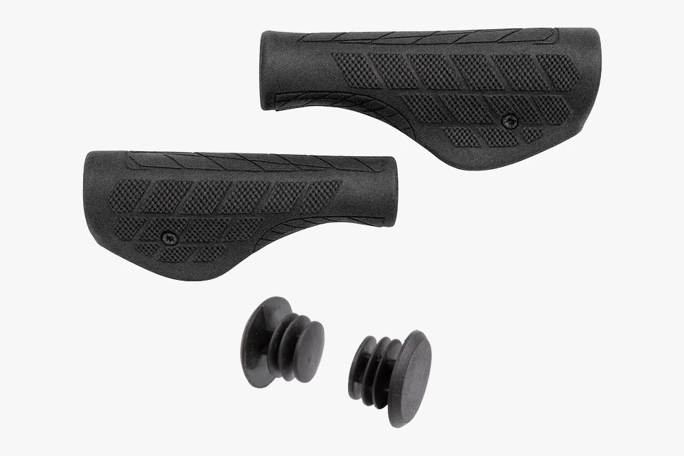 Pair of black wing-shaped Booda Bike Ergo grips with a patterned surface, above two black bar end plugs