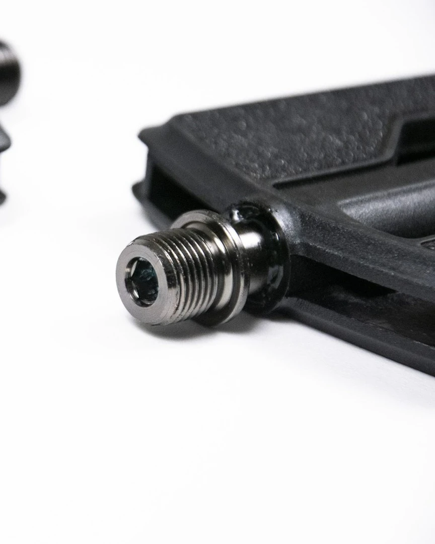Close-up of the Booda Bike Flat Pedal Plastic axle end with a hex socket, beside the black plastic body