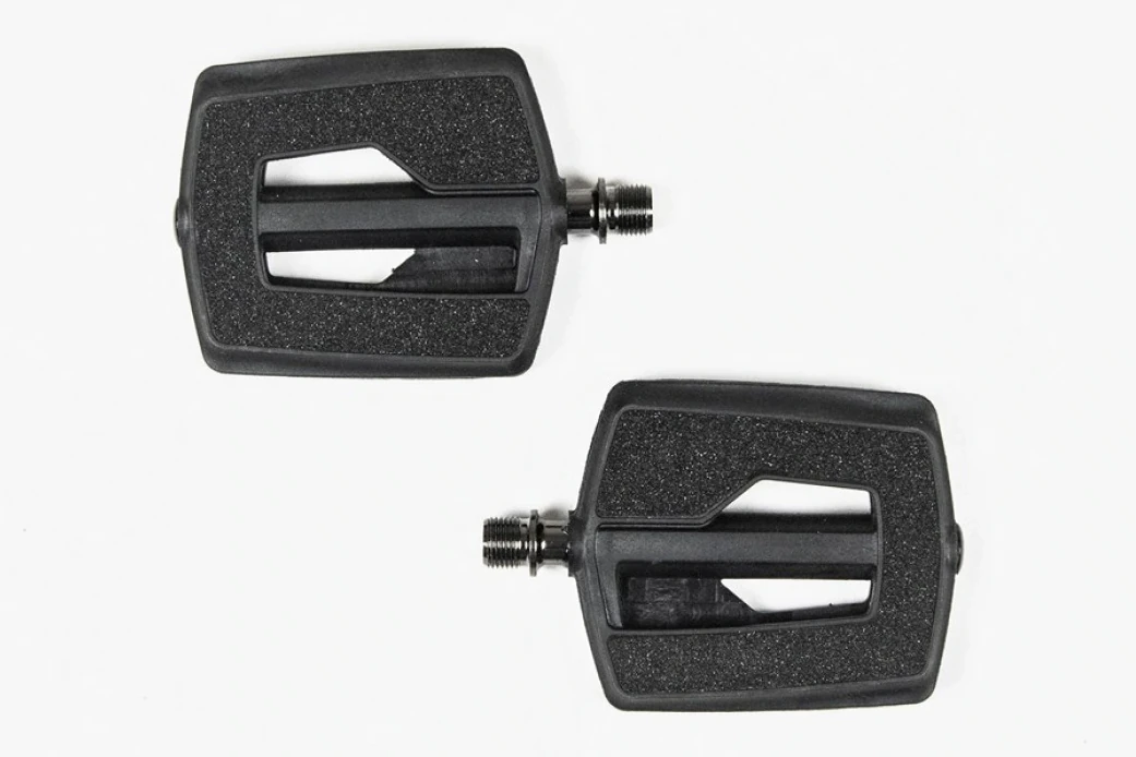 Pair of black Booda Bike Flat Pedal Plastic platform pedals with a textured top surface and a metal axle on each