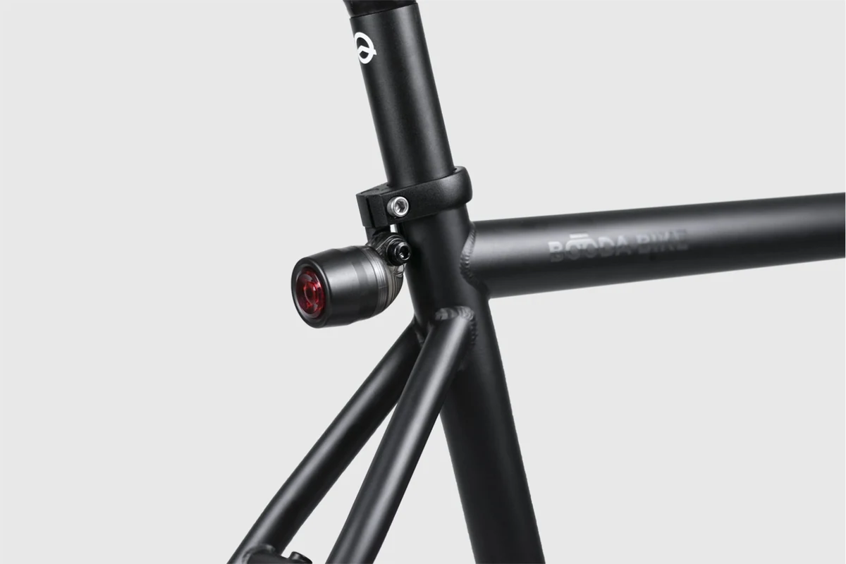 Seat cluster of a Booda Bike Banker with the seat clamp around the seat post and a small rear light