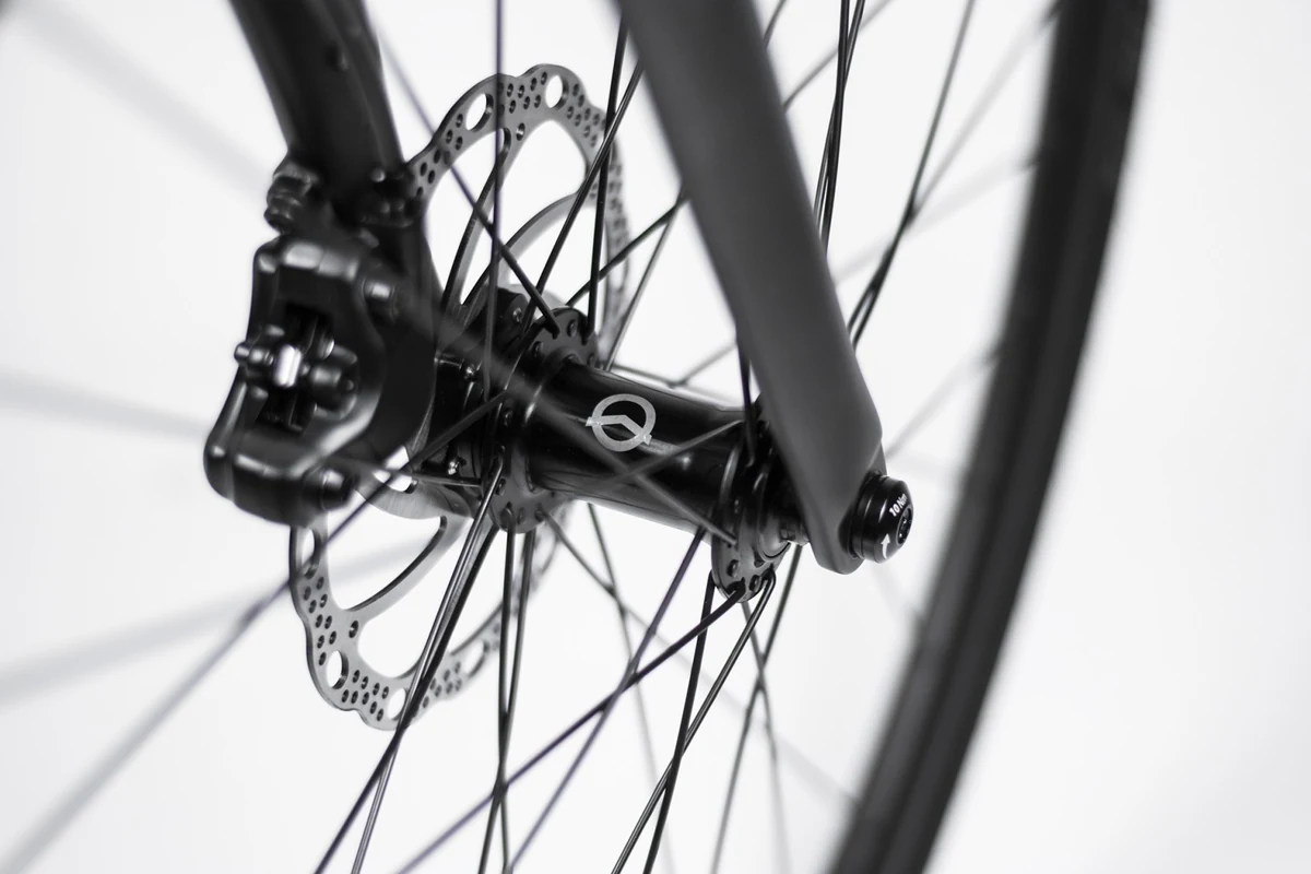 Front fork end and hub of a Booda Bike Banker with the thru axle head and a disc rotor