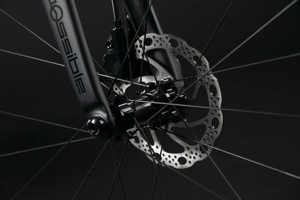 Front hub and disc rotor on the fork of a Booda Bike Pilot, with the Possible lettering on the fork leg