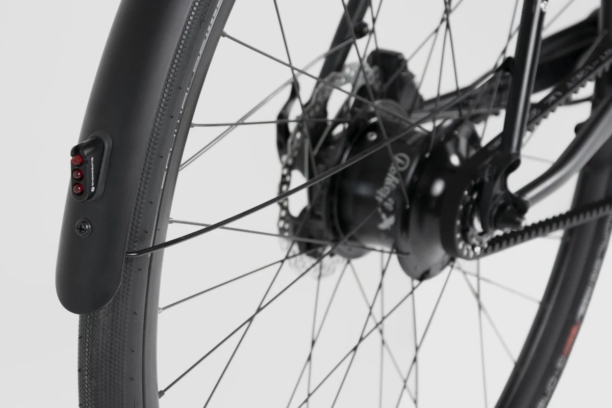 Rear mudguard following the rear wheel of a Booda Bike Pulse, with the hub and belt behind the spokes