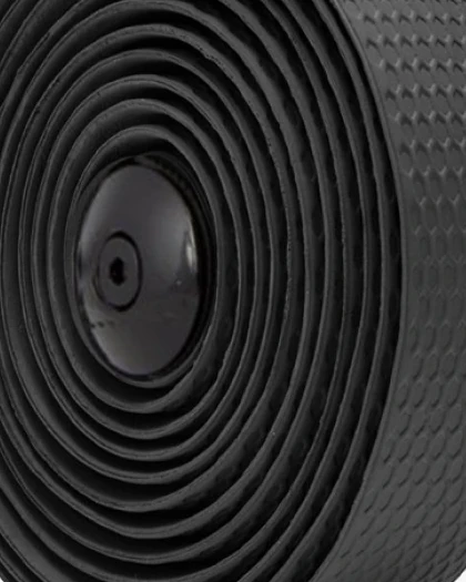 Close-up of a roll of black Multibender handlebar tape with a raised pattern and a black plug in its centre