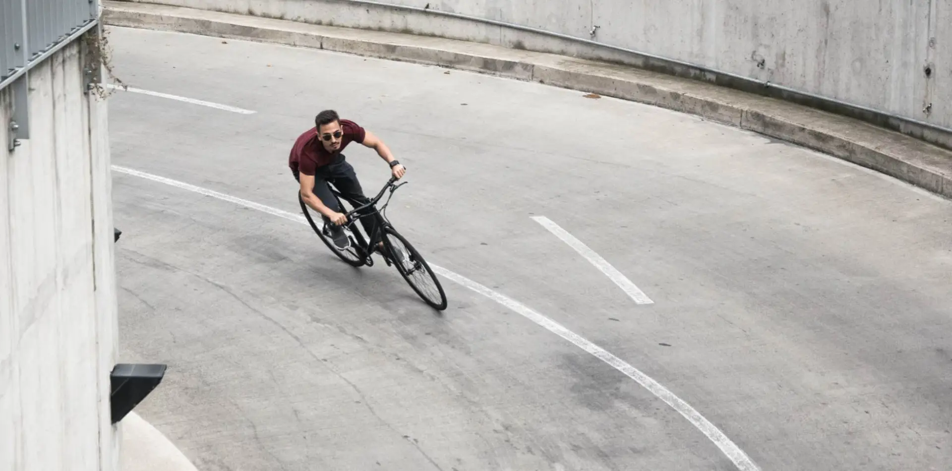Rider leaning into a curve on a Booda Bike Pilot single speed bike on a concrete ramp