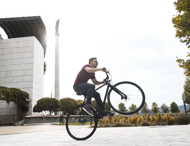 Rider doing a wheelie on a Booda Bike outdoors