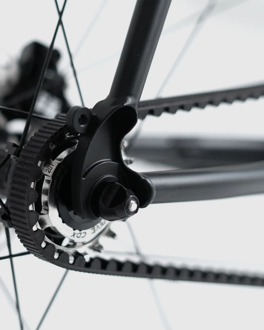 Rear dropout of a single-speed Booda Bike with the axle end and the Gates carbon belt on the rear sprocket
