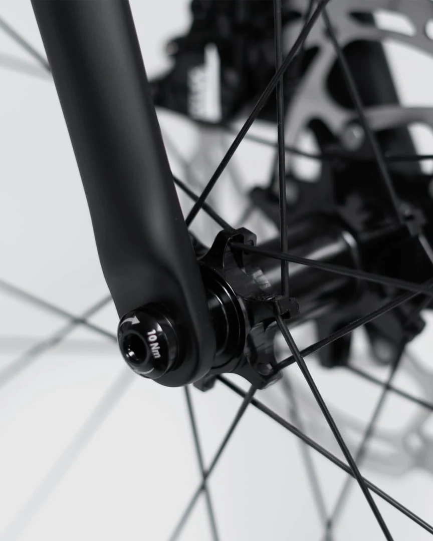 Front fork end of a Booda Bike Atlas with the thru axle head at the hub and a disc rotor behind