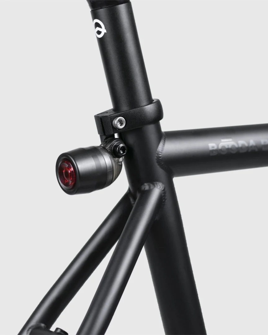 Seat cluster of a Booda Bike Banker with the seat clamp around the seat post and a small rear light