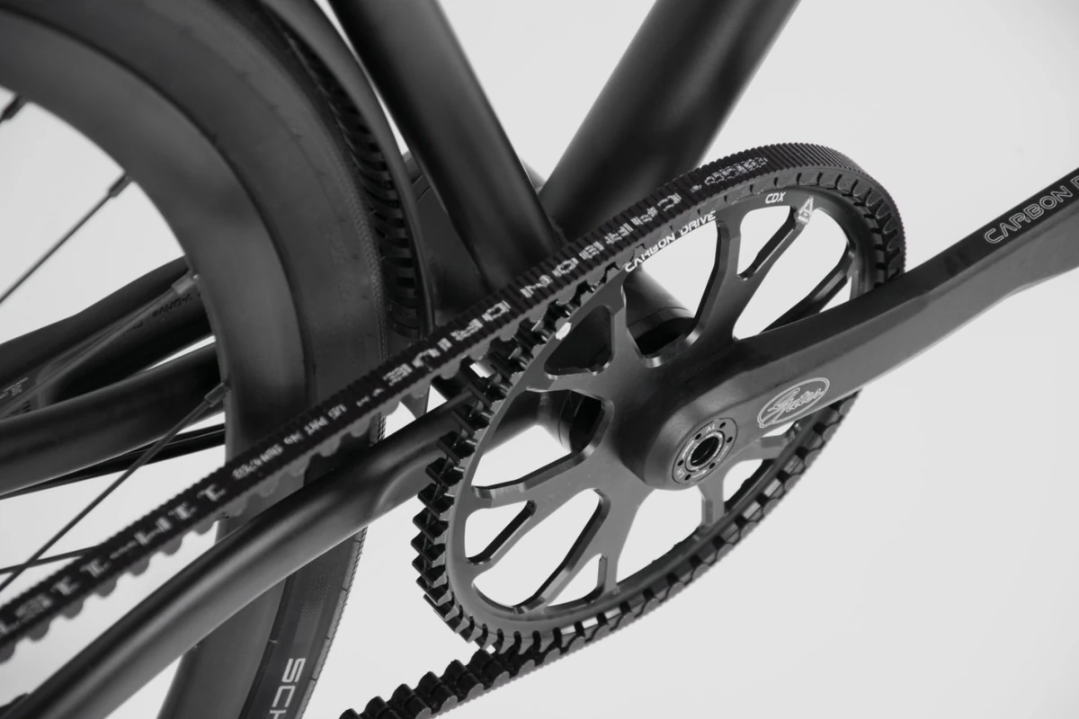 Close-up of a Gates Carbon Drive belt on a front sprocket and crank of a Booda Bike