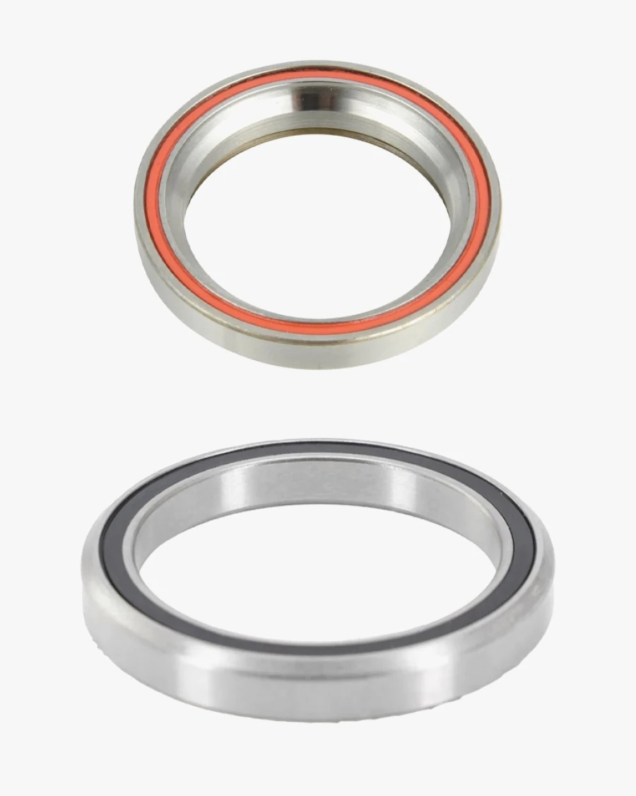 Two headset bearings, one above the other: a smaller one with an orange seal and a larger one with a black seal, both with a chamfered outer edge