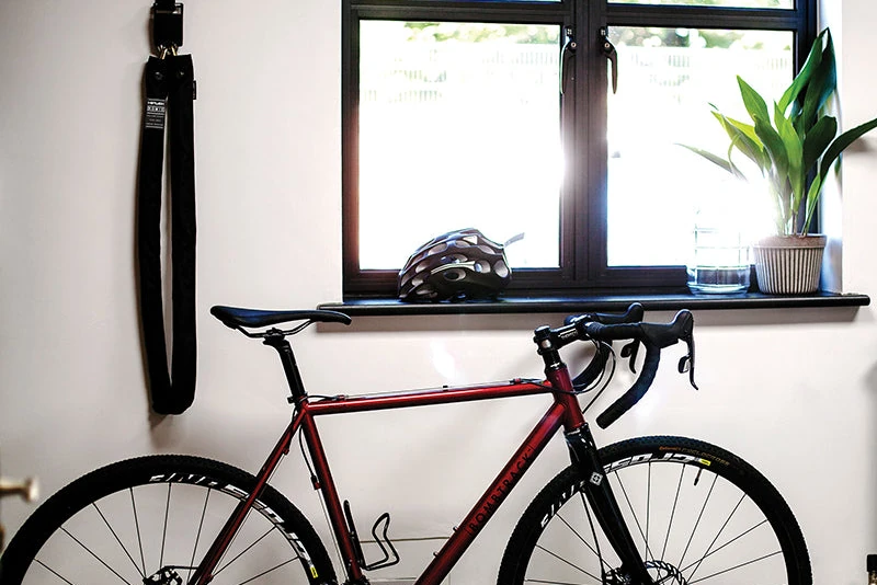 Bike at home locked with the long Hiplok HOME GOLD chain hanging from its wall hook