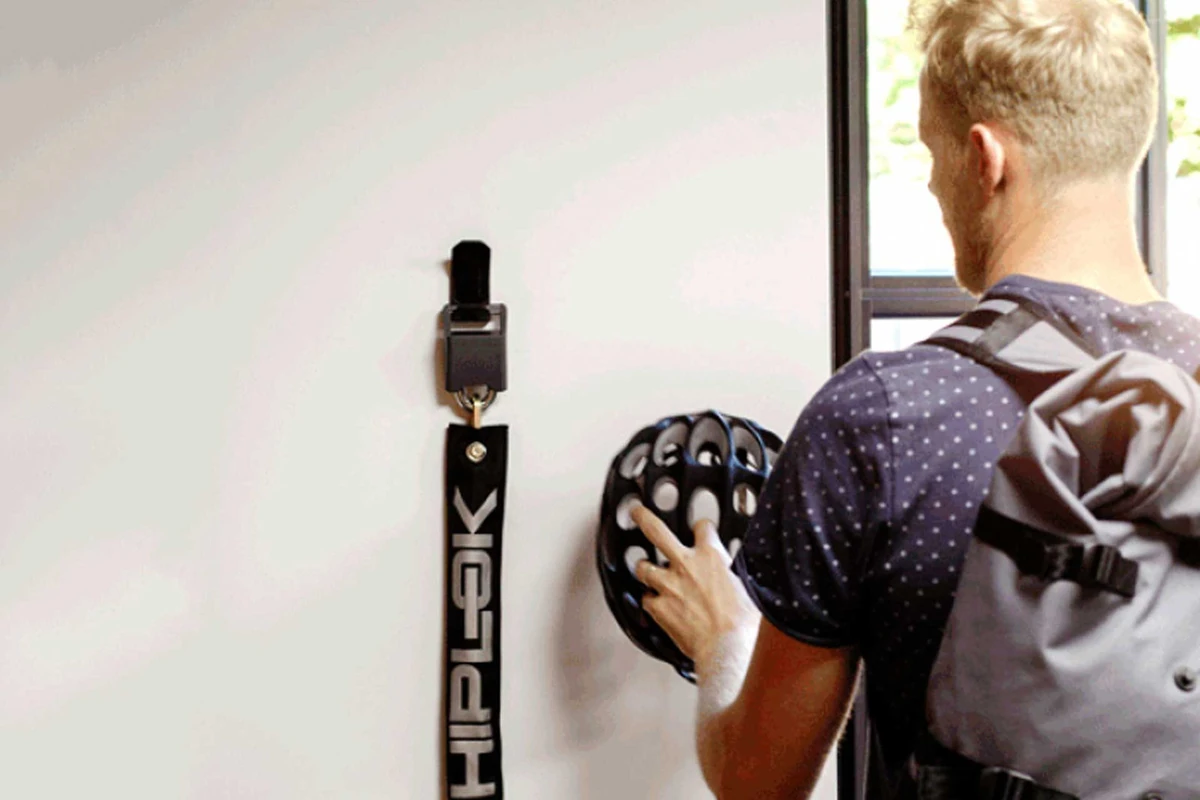 Hiplok Wall Hanger with helmet and chain lock stored on a wall