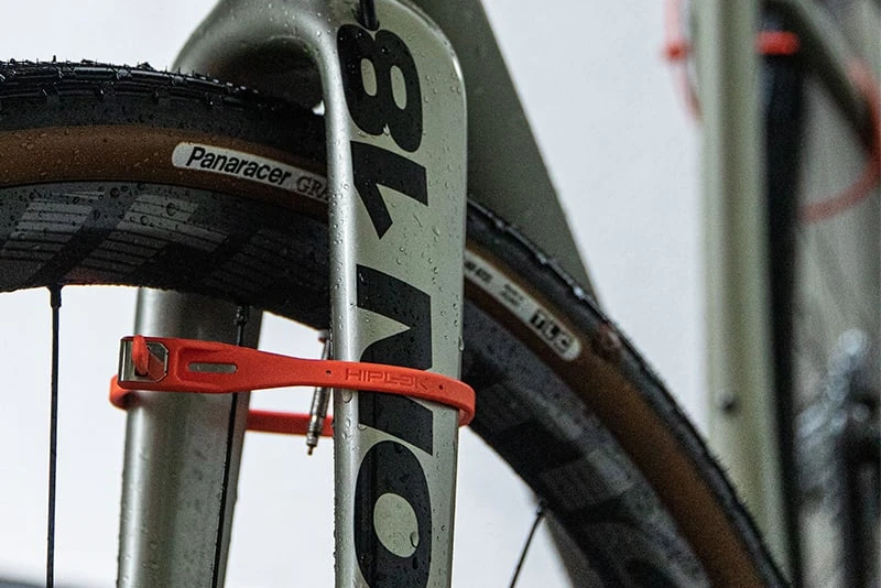 Hiplok Z LOK security tie locking the front wheel to the fork of a road bike
