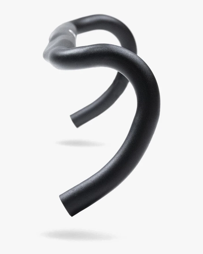 Three-quarter view of a black aluminium gravel drop handlebar showing the wide curve of the drops