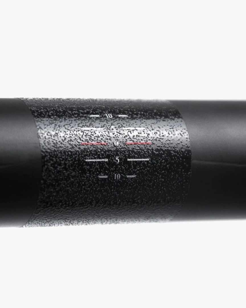 Close-up of the textured centre section of a black Possible carbon road handlebar with small printed markings