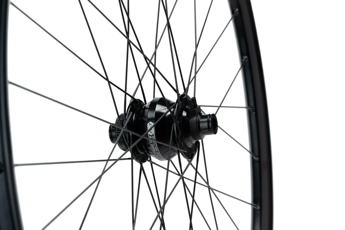 Possible dynamo front wheel, close-up of the black Shutter Precision PL-7 hub laced with black spokes