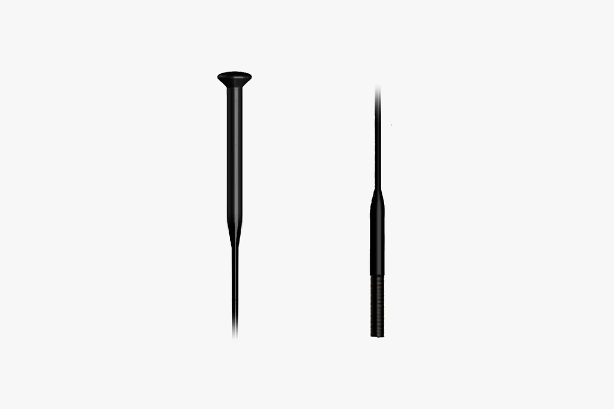 Two black Sapim CX-Ray straight pull spokes, one showing the flat head, one the bladed section