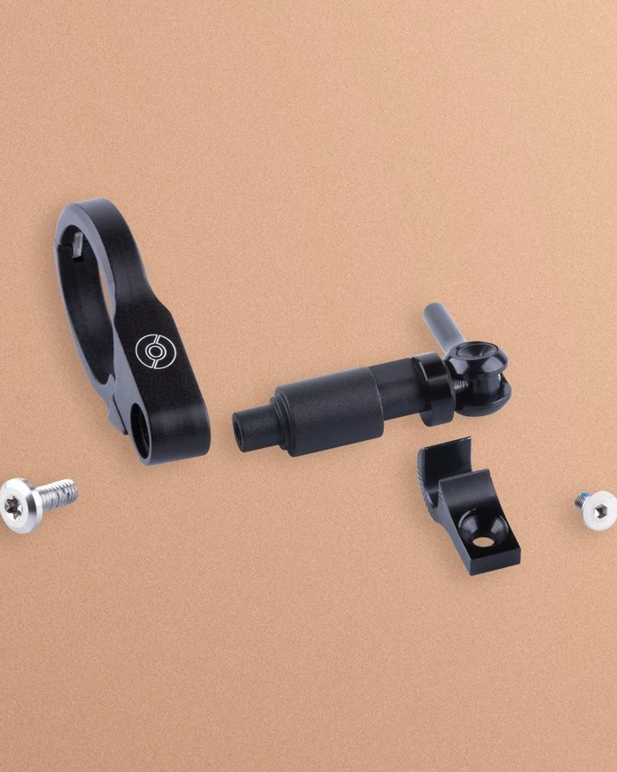 Airstream HBM parts laid out: split clamp, quick-release adapter and screws on a peach background