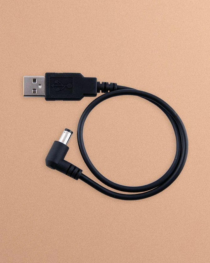 Airstream USB-A charging cable coiled on a peach background