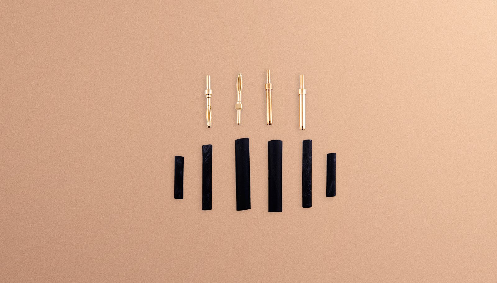 Gold connector set laid out: plugs and sleeves