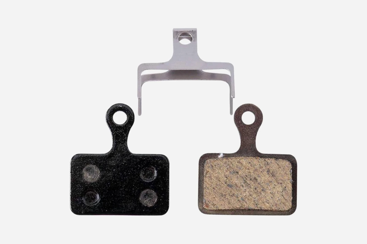 Pair of disc brake pads for Tektro HD-R290 and HD-R310 with the steel return spring, showing the pad backing plates and the friction surface